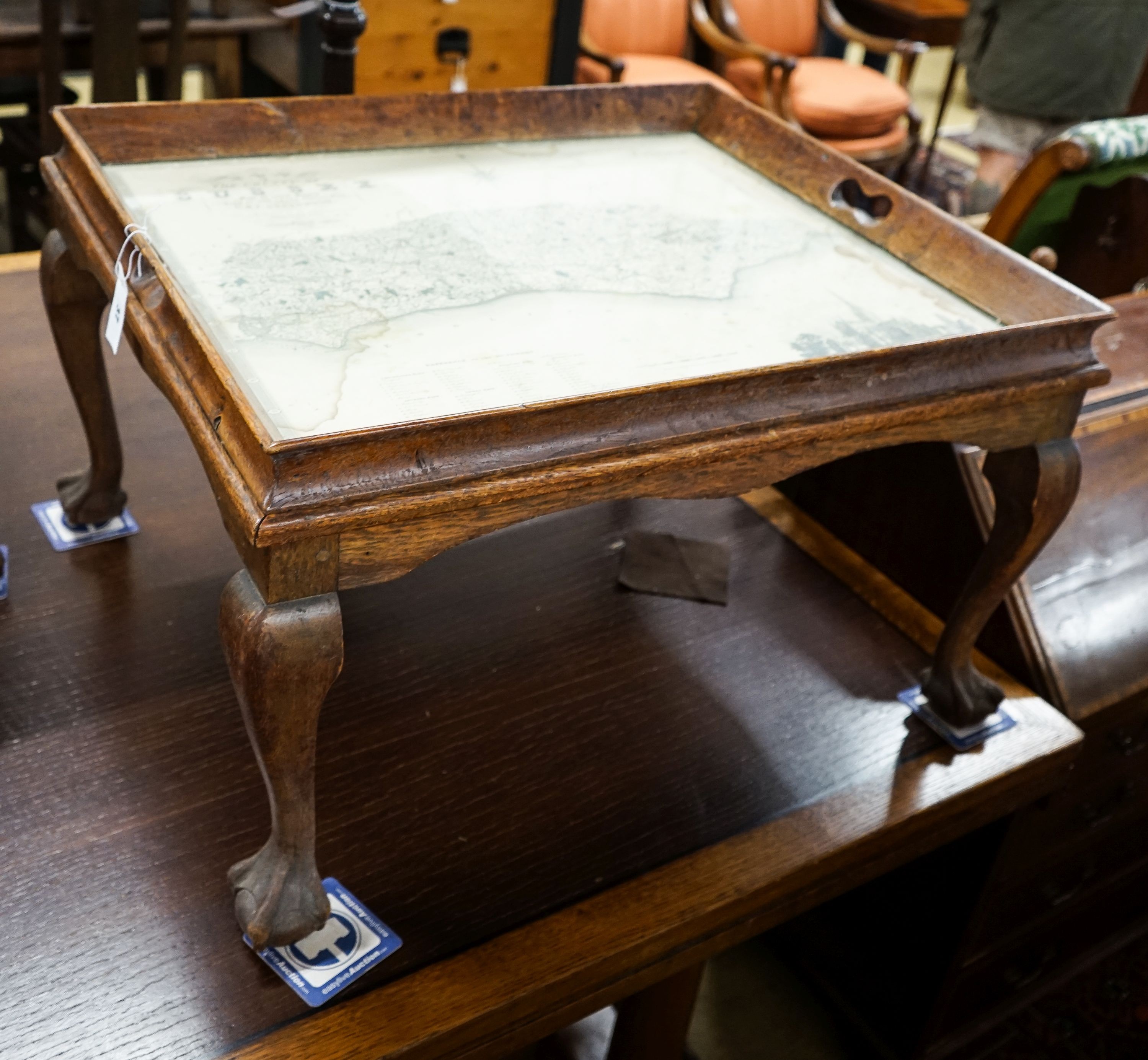 A rectangular oak tray top low table inset with a map of Sussex on ball and claw stand, width 81cm, depth 70cm, height 47cm